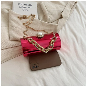 Pink metallic cylinder evening bag with pearl clasp, showing phone capacity and gold chain