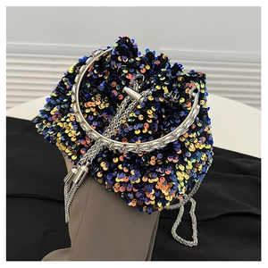 Close-up of multicolor sequins and silver round handle on a luxury bucket bag