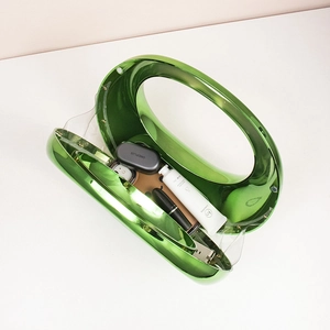 Detail of green acrylic evening bag interior with lipstick and earbuds essentials