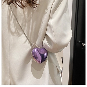 Close-up of a mini purple heart-shaped acrylic chain bag with a glossy metallic finish