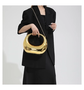 Polished gold acrylic moon evening bag with sleek metallic finish and fine chain strap