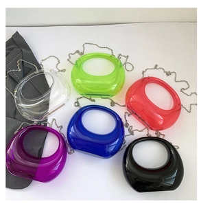 Detail shot of colorful transparent acrylic crescent handbags with stylish metal chains