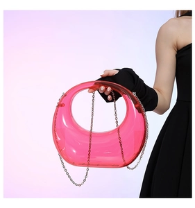 Detail of translucent pink acrylic crescent bag with fine silver chain strap