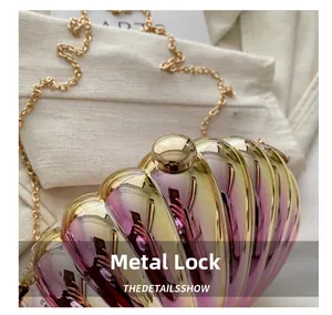 Detailed macro shot of the golden spherical metal clasp on a colorful shell clutch bag