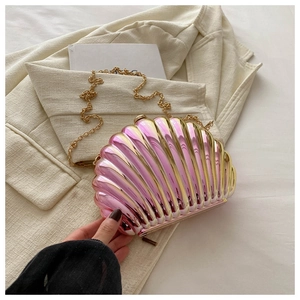 Macro view of shell-shaped evening bag with pink gold gradient texture and gold chain