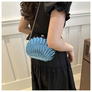 Blue shell-shaped acrylic evening bag featuring gold chain strap and textured finish
