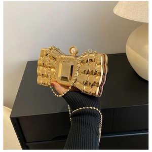 Golden bow-shaped acrylic evening clutch bag with pearl clasp and metal chain strap