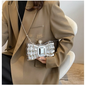Silver acrylic box bag with metal bow and pearl clasp for elegant evening parties