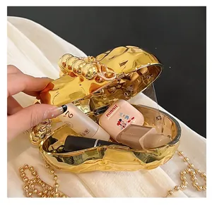 Close-up of golden acrylic evening clutch featuring ice crack texture and beaded handle