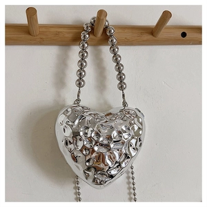 Silver heart-shaped acrylic evening bag with cracked texture and metal bead handle