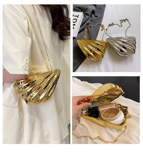 Detailed view of the internal storage and metallic finish of the shell clutch bags