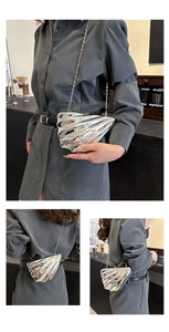 Detailed side and back view of silver acrylic shell clutch with metallic chain strap