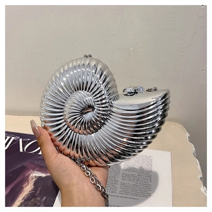 Silver nautilus shell clutch bag featuring a sleek chrome finish and metallic chain strap
