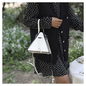 Detail of the triangle pyramid handbag featuring black and white leather with drawstring