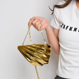 Golden acrylic shell evening bag with mirror finish and elegant metal chain strap