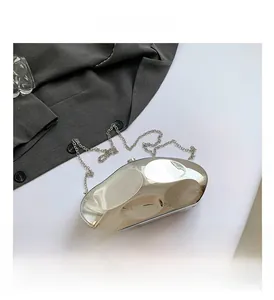 Macro shot of silver metallic pebble clutch with reflective surface and chain strap
