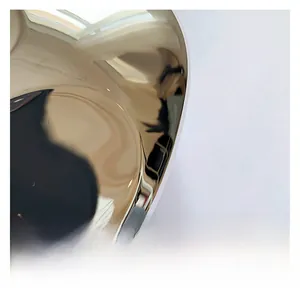 Detailed view of the mirror-polished gold metal hardware on an acrylic stone evening clutch