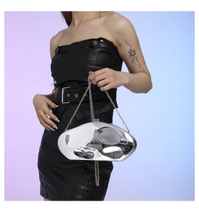 Close-up of a silver irregular geometric acrylic clutch bag with a polished mirror finish