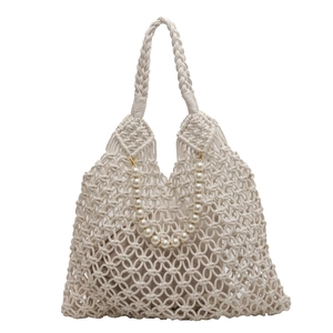Detail of white macrame tote bag with pearl handle and inner fabric pouch