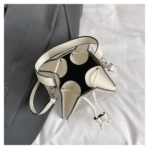 Détail du sac seau blanc avec strass argentés brillants et fermeture par cordon en cuir