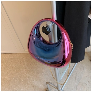Detail of blue-purple gradient acrylic box bag with round handle and gold chain strap