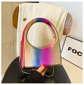 Close-up of candy-colored gradient acrylic clutch with metallic chain and round handle