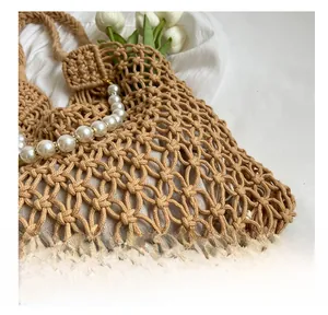 Close-up of woven mesh beach bag with pearl handle and beige cotton lining details
