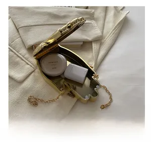 Internal storage of the gold acrylic clutch showing space for lipstick and makeup