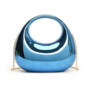 Macro shot of electric blue acrylic bag with mirror finish and golden chain strap