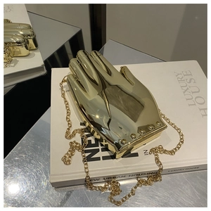 Artistic gold palm shaped acrylic clutch bag with a mirror finish and metal chain strap