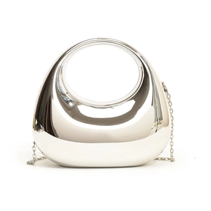 Detail of silver mirror finish acrylic clutch with integrated handle and metal chain strap