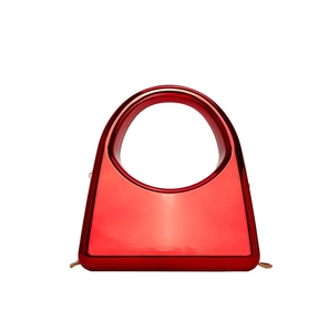 Detail view of red trapezoid acrylic evening bag with gold chain and circular handle