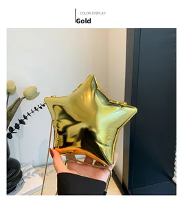 Detail of star-shaped golden mirror acrylic evening bag with a thin metal chain strap