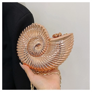 Rose gold nautilus shaped evening bag with butterfly clasp and elegant gold chain strap
