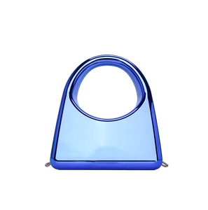 Detail of bright blue metallic acrylic clutch bag with semicircular hollow handle