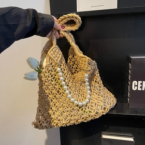 Detailed knit of khaki hollow mesh beach bag featuring elegant white pearl bead strap