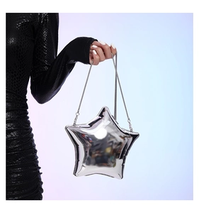 Detail of silver metallic star-shaped crossbody bag with slim metal chain strap