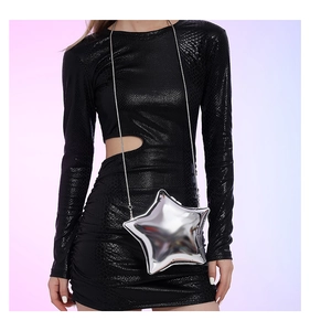 Detail of silver star-shaped acrylic evening bag with metal chain on a black dress