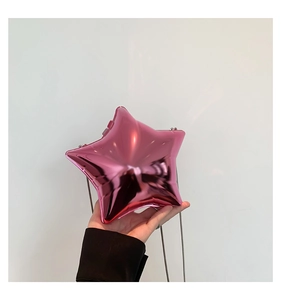 Close-up of pink star-shaped acrylic evening bag with metallic mirror finish and chain