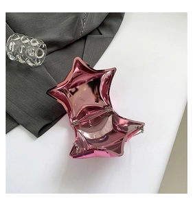 Detailed macro view of the metal pink star acrylic clutch bag showing interior hinge and chain
