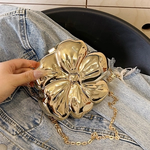 Elegant gold floral evening clutch bag with metallic mirror finish and chain strap