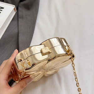 Polished gold heart-shaped metal clutch with chain strap and rectangular clasp detail