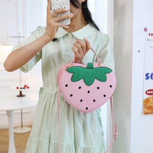 Chic pink strawberry crossbody bag with green glitter leaves and adjustable strap