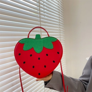 Red strawberry shaped shoulder bag with green sequin leaves and crossbody strap