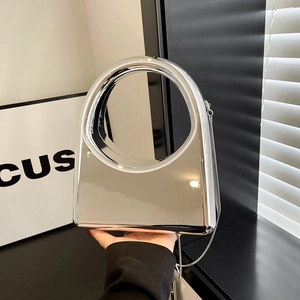 Chic silver acrylic clutch with mirror finish and circular cutout handle for evening