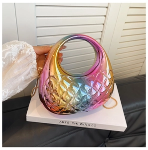 Close-up of rainbow gradient shell clutch with diamond quilting and gold chain strap