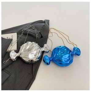 Detail of candy-shaped metallic clutch bags in silver and electric blue with ball chains