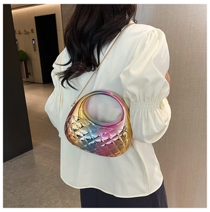 Close-up of holographic shell-shaped crossbody bag with diamond quilted texture and chain