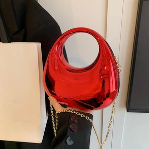 Chic red acrylic moon handbag with a circular top handle and gold chain strap