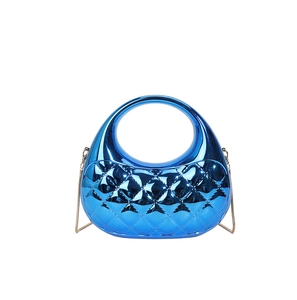 Detail of blue candy-color acrylic clutch with quilted pattern and gold chain strap